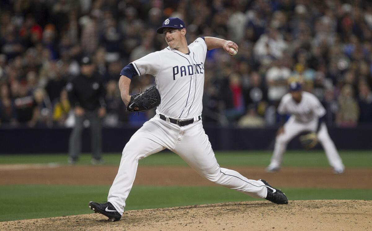 The Padres' closer Ryan Buchter pitches to the Giants in the ninth inning at Petco Park.