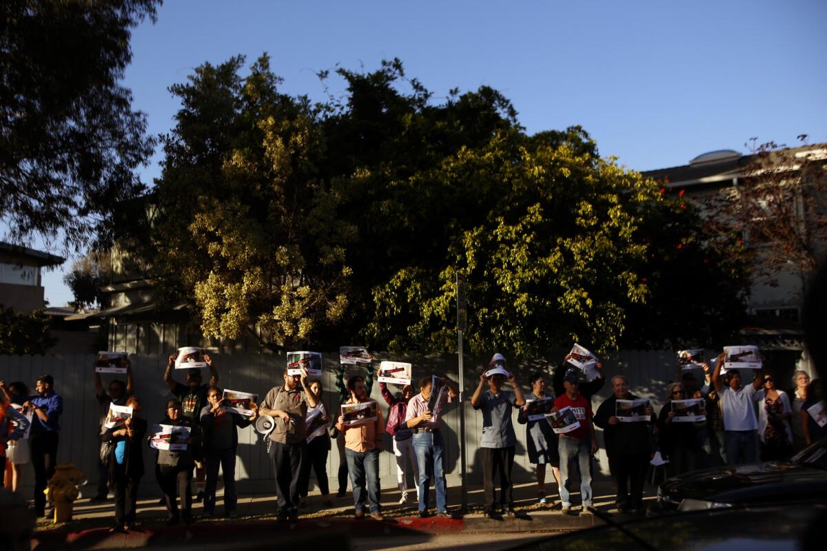 Activists protest outside Globe Homes and Condos in Venice on April 1. In Santa Monica, the City Council voted unanimously to support new rules that would ban full-time vacation rentals.