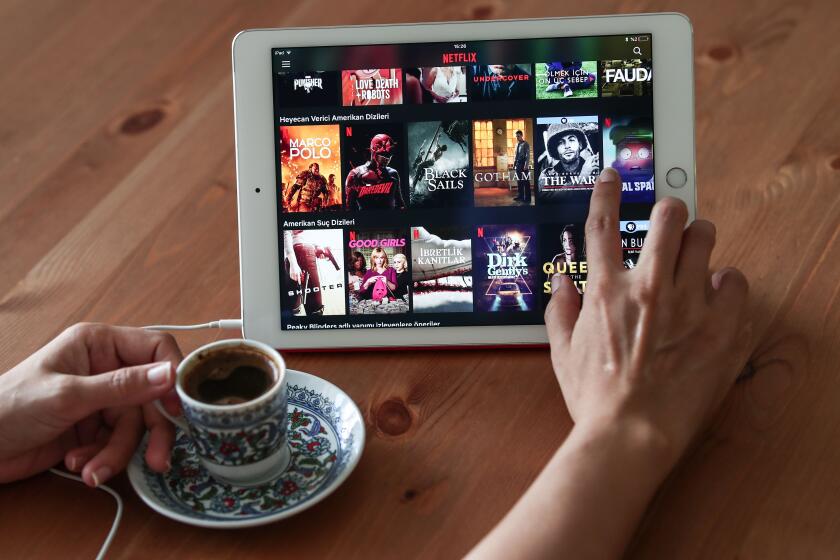Mandatory Credit: Photo by SEDAT SUNA/EPA-EFE/REX (10352876d) A woman browses titles on Netflix platform at Turkish traditional cafe in Istanbul, Turkey, 02 August 2019. According to media reports, a Turkish regulation gave authority to the Turkish Radio and Television Supreme Council (RTUK) to regulate and monitor sound and visual broadcasting, including online streaming services like Netflix, other contents shared on social media platforms, and online news outlets on a regular basis. Turkish Radio and Television Supreme Council to monitor online broadcasting content, Istanbul, Turkey - 02 Aug 2019 ** Usable by LA, CT and MoD ONLY **