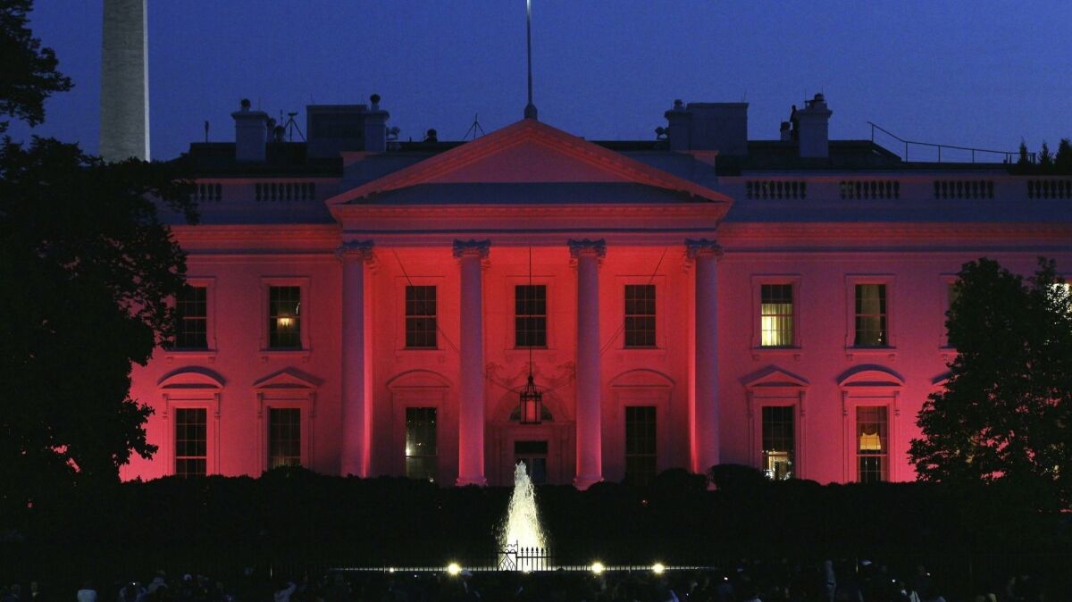 The White House is bathed in pink light for National Breast Cancer Awareness Month in Washington on Oct. 14, 2010.
