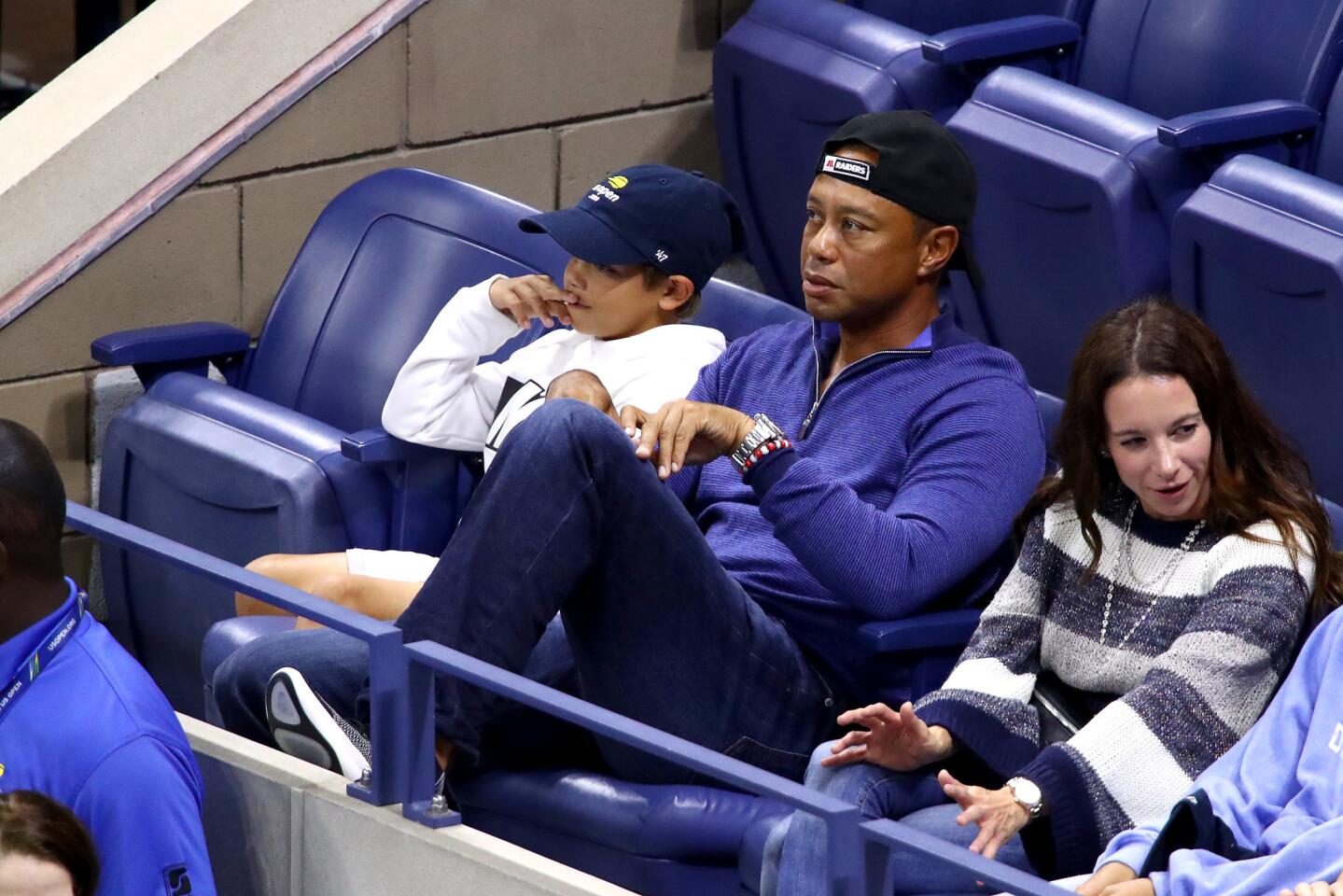 Professional golfer Tiger Woods cheers on Rafael Nadal of Spain with his son Charlie at the 2019 U.S. Open in Queens on Monday, Sept. 2, 2019.