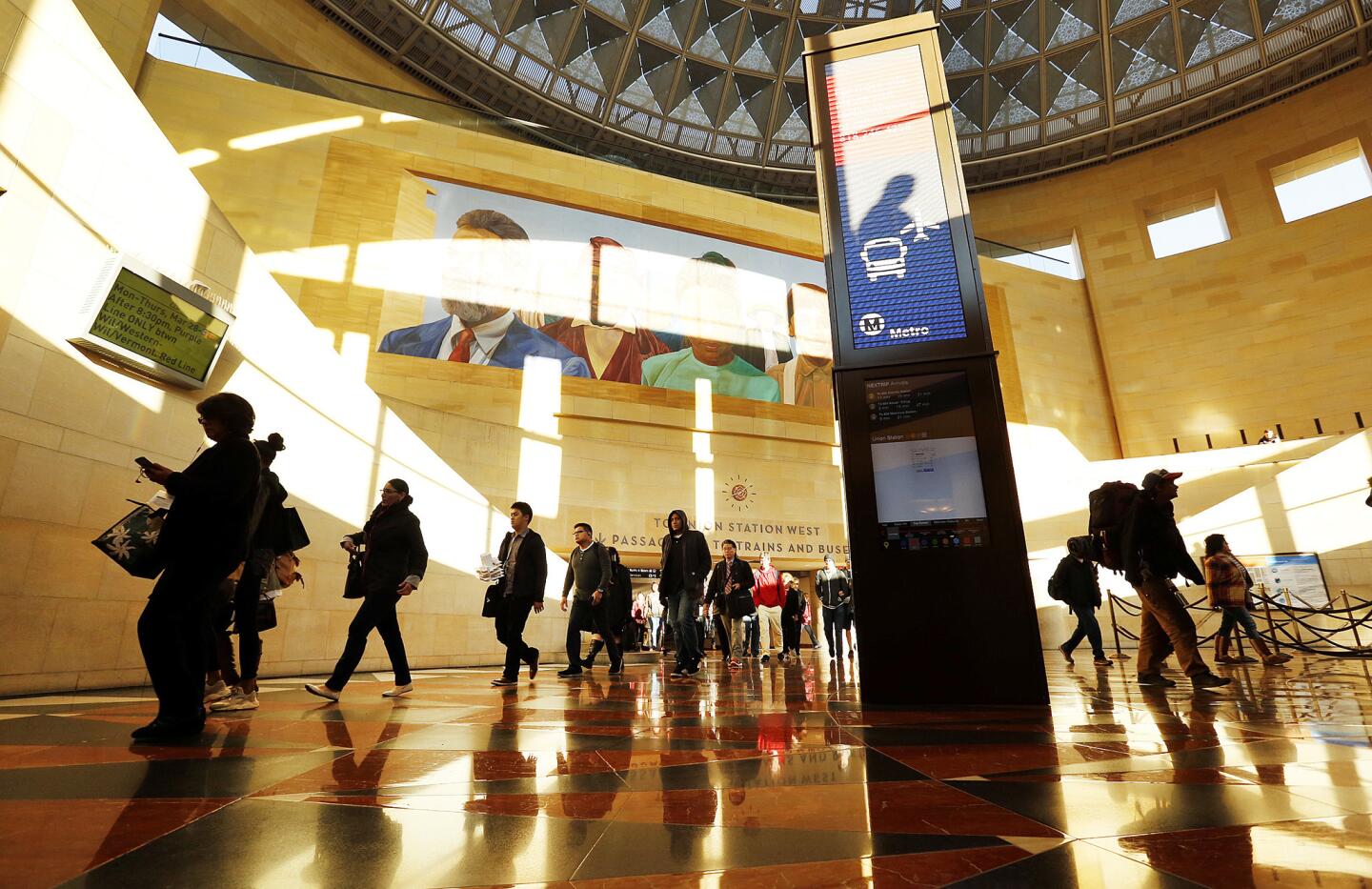 Passengers pass the new information kiosk in the Patsaouras Transit Plaza at historic Union Station, which officials hope to expand from a transit hub to more of an urban destination.