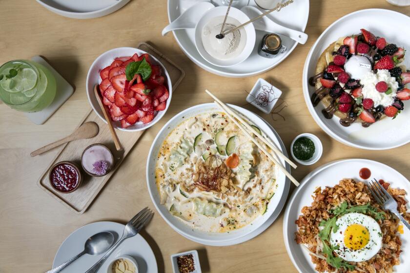 LOS ANGELES, CALIFORNIA - Aug. 30, 2019: A selection of dishes at Spoon by H, a dessert and Korean food cafe by chef/owner Yoonjin Hwang: (clockwise L to R) strawberry shaved snow; teaffee cube late set; triple waffle, loaded with bananas, berries, ice cream and whipped cream; kimchi rice with a fried egg; and a bowl of pork and dumplings soup; on Monday, Sept. 30, 2019, at the cafe's location in a strip mall in Fairfax District in Los Angeles. (Photo / Silvia Razgova) Assignment ID: 467501