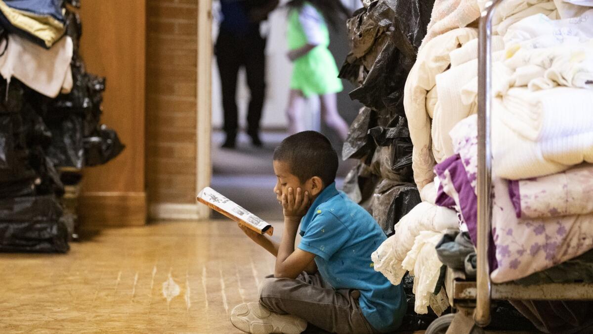 Danny Ventura, 7, from Guatemala, reads a book while staying at Blythe Central Seventh-Day Adventist Church.