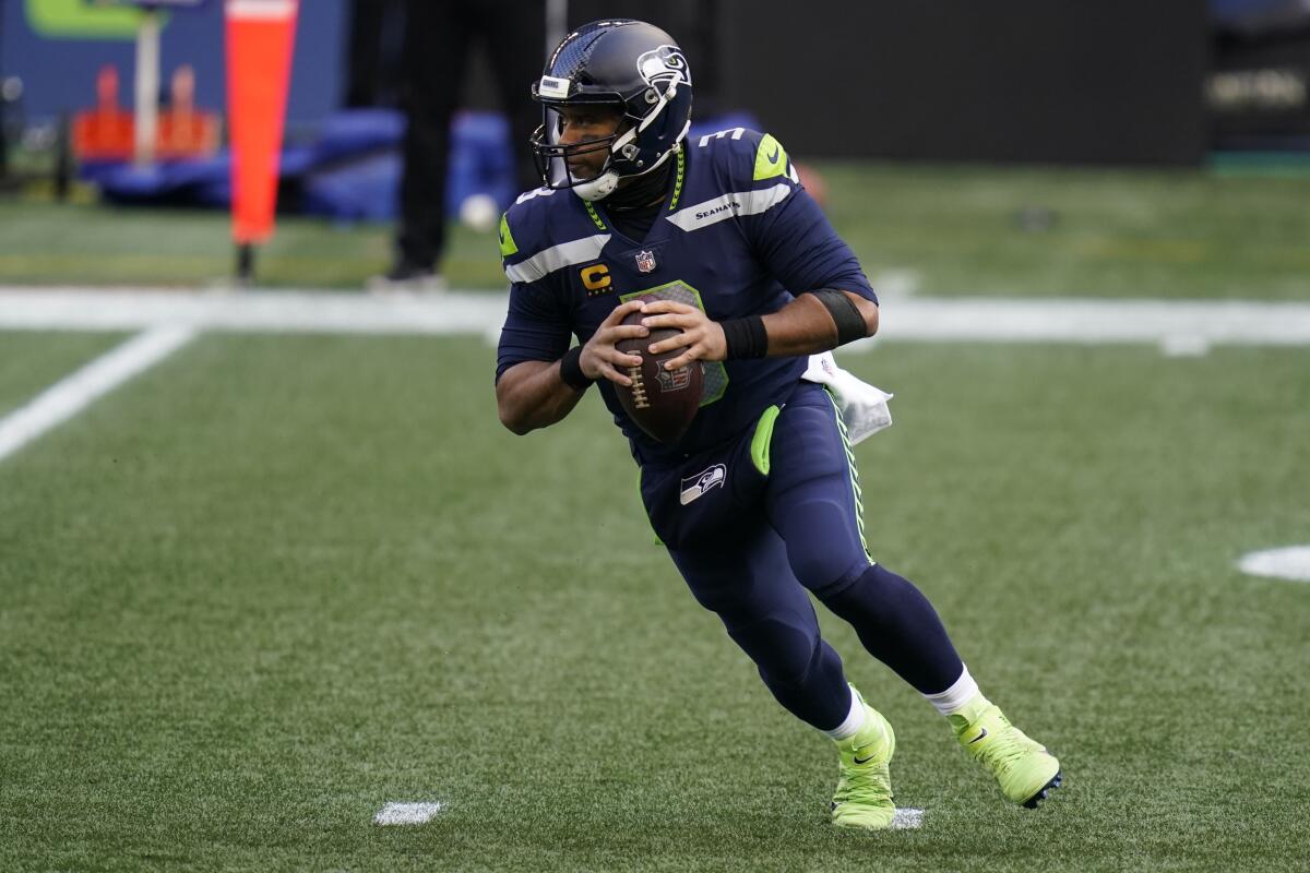 Seattle Seahawks quarterback Russell Wilson looks to pass against the Rams on Dec. 27.