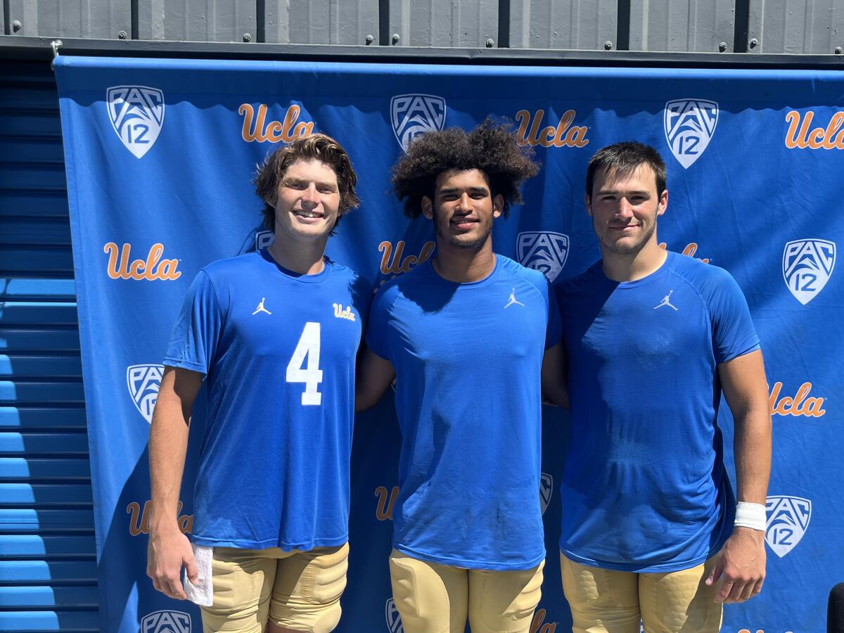 UCLA quarterbacks Ethan Garbers, Dante Moore and Collin Schlee pose for a photo after practice