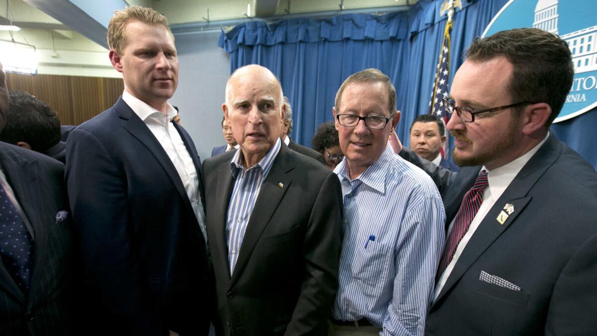 Gov. Jerry Brown, second from left, flanked by Republicans, Assembly Leader Chad Mayes, of Yucca Valley, left, Tom Berryhill, of Twain Harte, and Devon Mathis, of Visalia, right, on July 17, 2017.