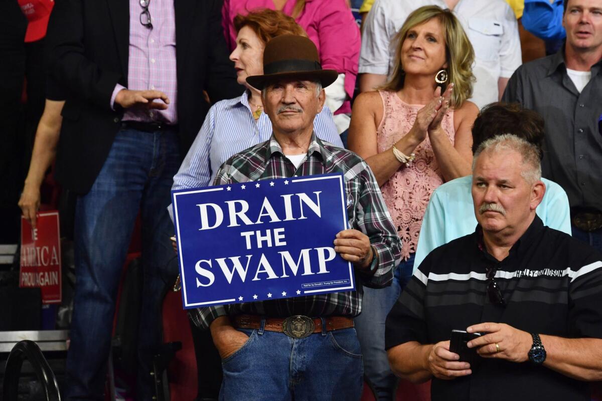 An attendee at President Trump's rally Sept. 6 in Billings, Mont., holds up a sign quoting a key Trump slogan from the 2016 campaign.