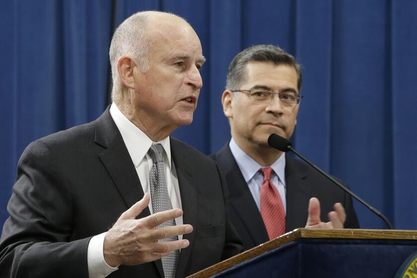 California Gov. Jerry Brown, left, accompanied by California Attorney General Xavier Becerra, responds to remarks made U.S. Attorney General Jeff Sessions, Wednesday, March 7, 2018, in Sacramento, Calif. (AP Photo/Rich Pedroncelli)