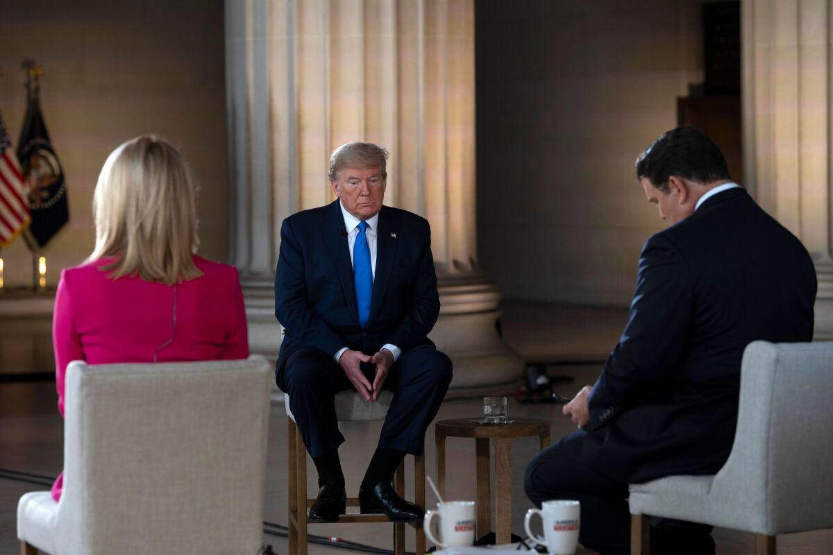 President Trump pauses during a Fox News virtual town hall on Sunday at the Lincoln Memorial in Washington.