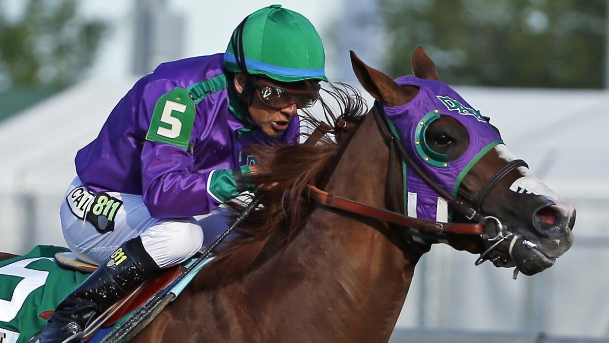 Jockey Victor Espinoza rides California Chrome to victory in the Kentucky Derby on May 3. Espinoza's joy at winning the famed horse race has been matched by his generosity.
