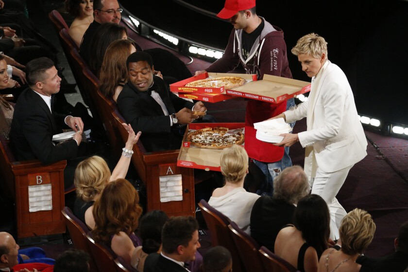 Ellen DeGeneres hands out some pizza during the Academy Awards.