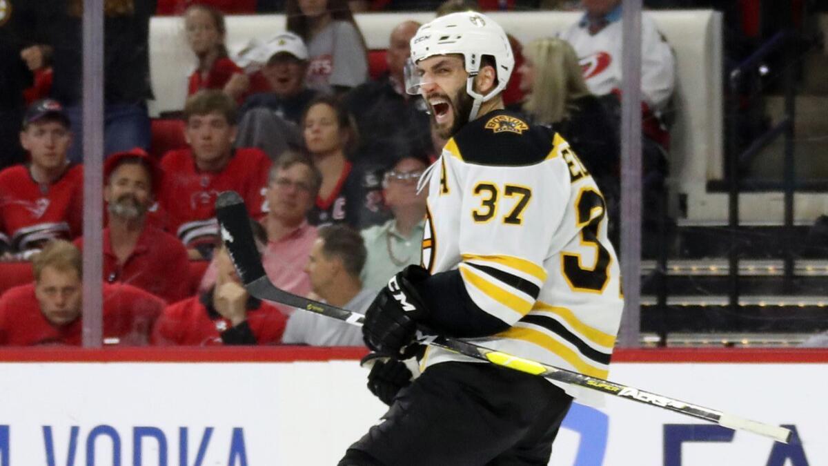 Boston Bruins forward Patrice Bergeron celebrates after teammate Curtis McElhinney, not pictured, scored during third period of a 4-0 victory over the Carolina Hurricanes on May 16.
