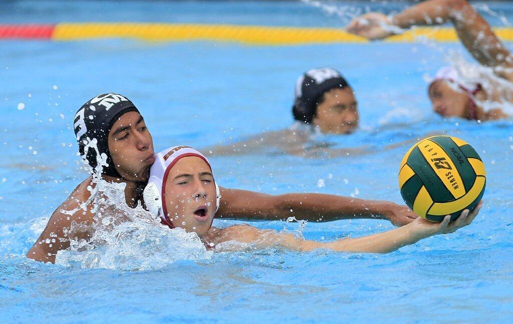 Costa Mesa High's Jose Palacios, top left, pressures Estancia's Aaron Will, bottom left, during the first half in an Orange Coast League game on Wednesday.