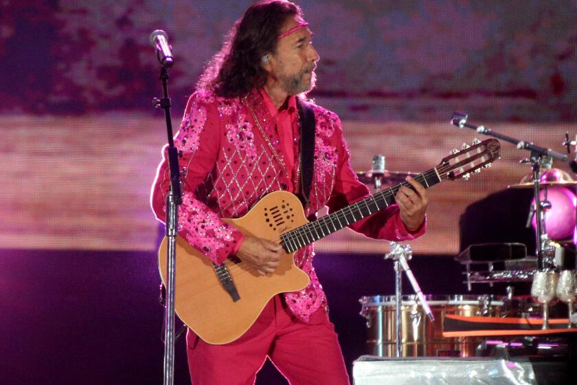 Los Bukis frontman and co-founder Marco Antonio Solis plays with the legendary Mexican grupera band for their Una Historia Cantada Tour at the Los Angeles Coliseum on Thursday, Aug. 18, 2022.