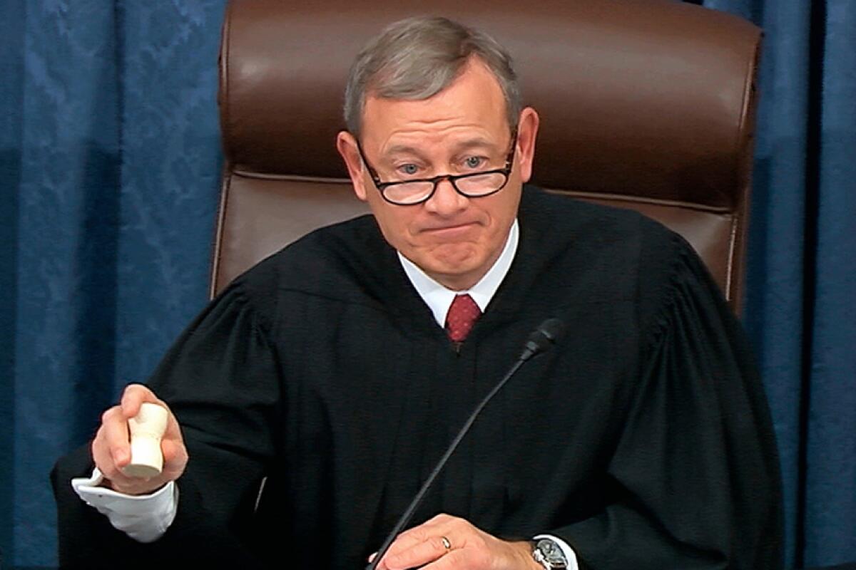 John G. Roberts Jr. in robes, wielding an unusually shaped gavel 