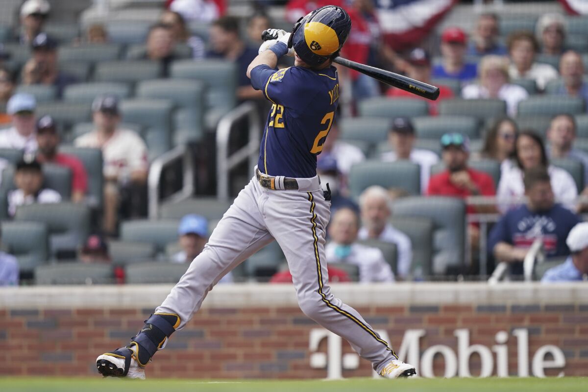 Milwaukee Brewers left fielder Christian Yelich (22) strikes out during the first inning of Game 4 of a baseball National League Division Series against the Atlanta Braves, Tuesday, Oct. 12, 2021, in Atlanta. (AP Photo/Brynn Anderson)