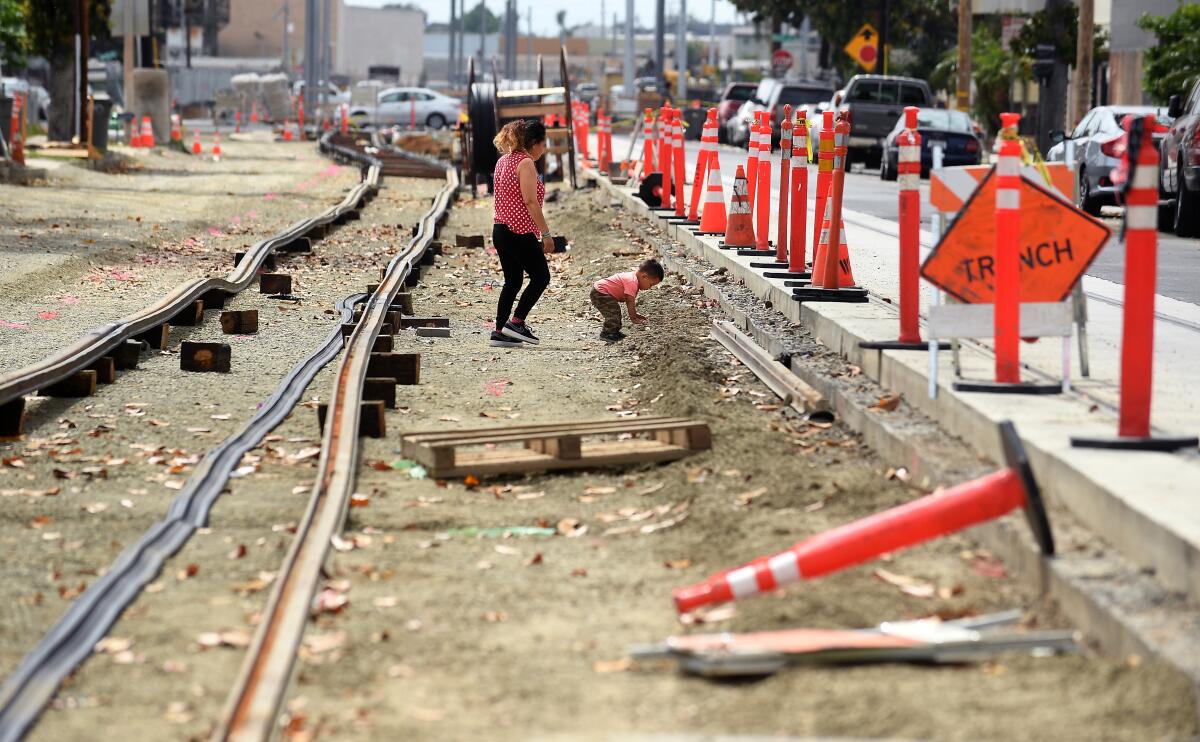 A woman and child along rail tracks