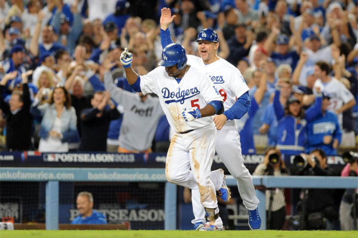 Tim Wallach, right, congratulates Juan Uribe after the latter's two-run homer against Atlanta last October.