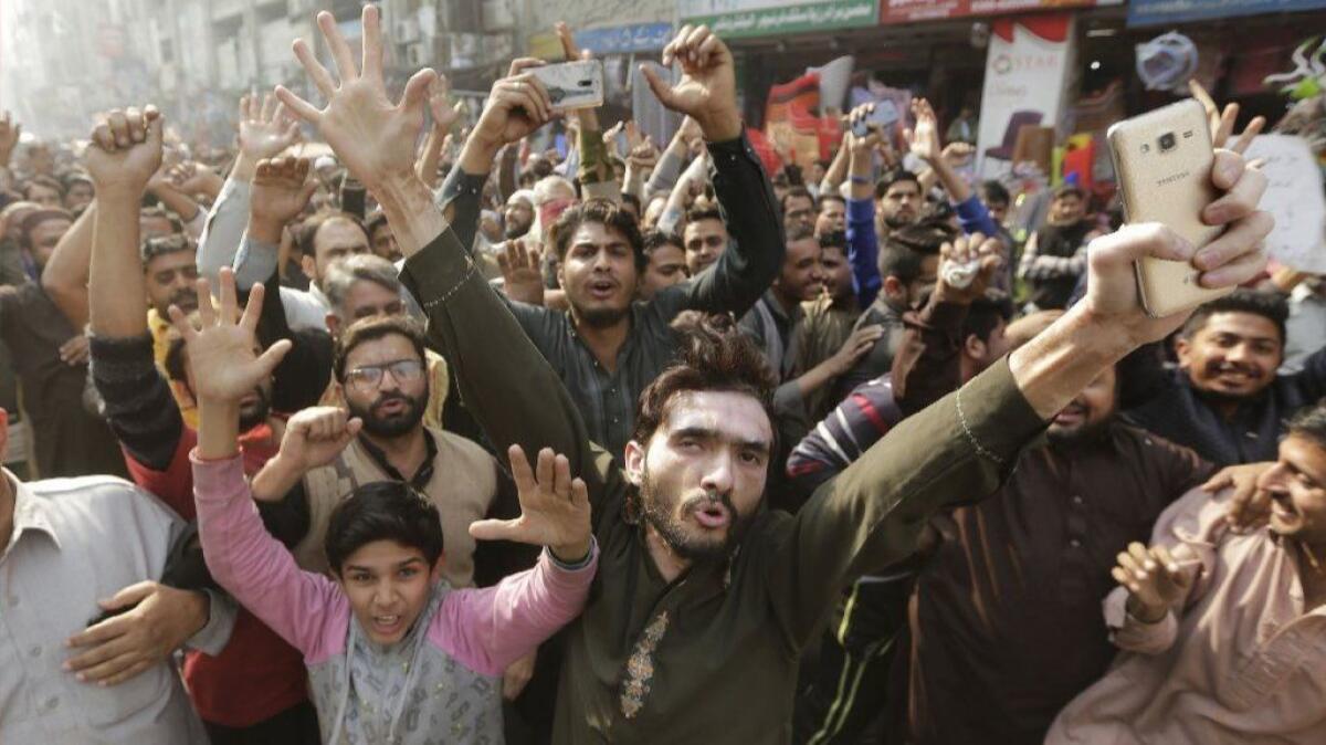 Demonstrators shout slogans to protest a police crackdown against their sit-in blocking a key road in Islamabad, Pakistan, on Nov. 25.