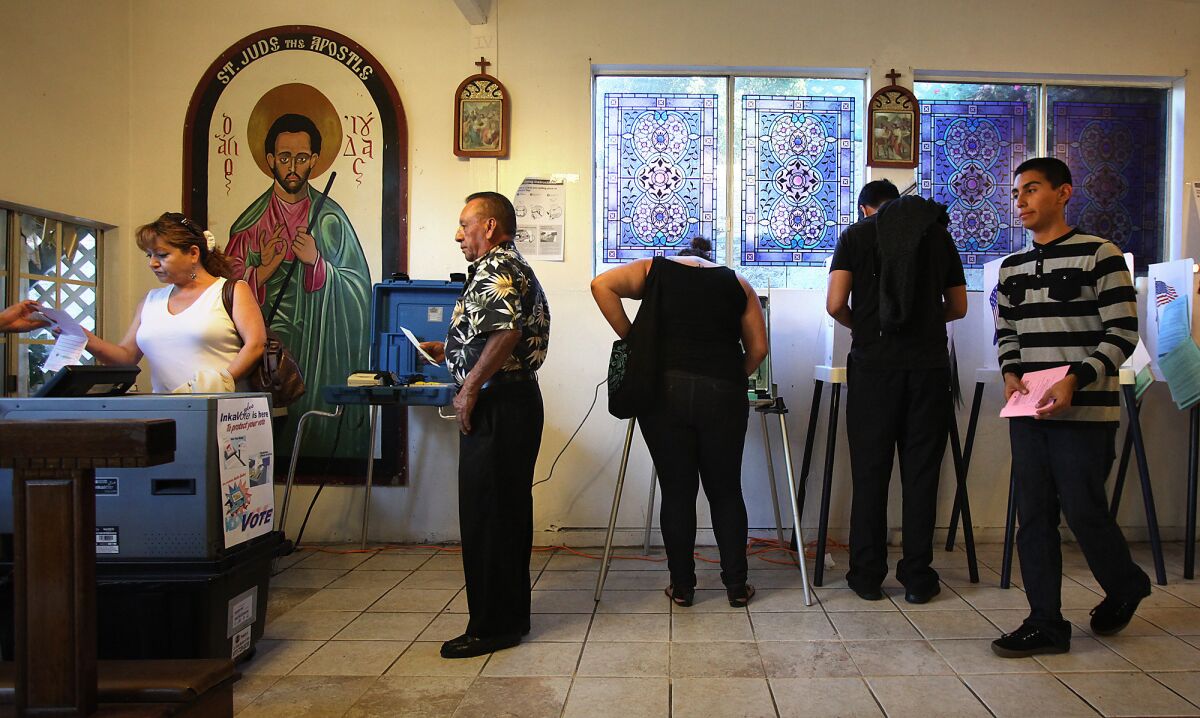 Voters make their way in and out of a polling place at the House of Mercy in Los Angeles in November 2012.