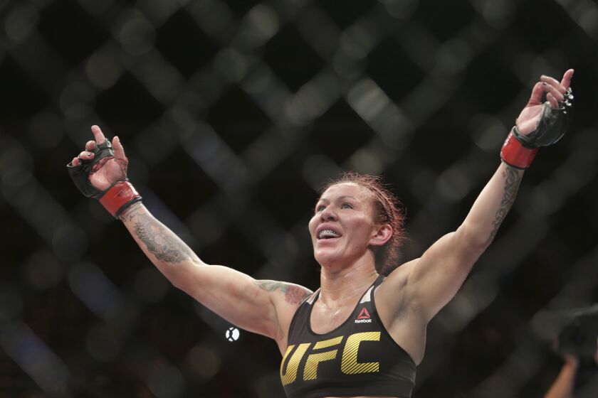 FILE - Brazil's Cris "Cyborg" Justino celebrates after defeating Sweden's Lina Lansberg during a UFC Fight Night mixed martial arts bout in Brasilia, Brazil, Sept. 25, 2016. Justino is making her professional boxing debut in her native Curitiba, Brazil, on Sunday, Sept. 25, 2022. (AP Photo/Eraldo Peres, File)