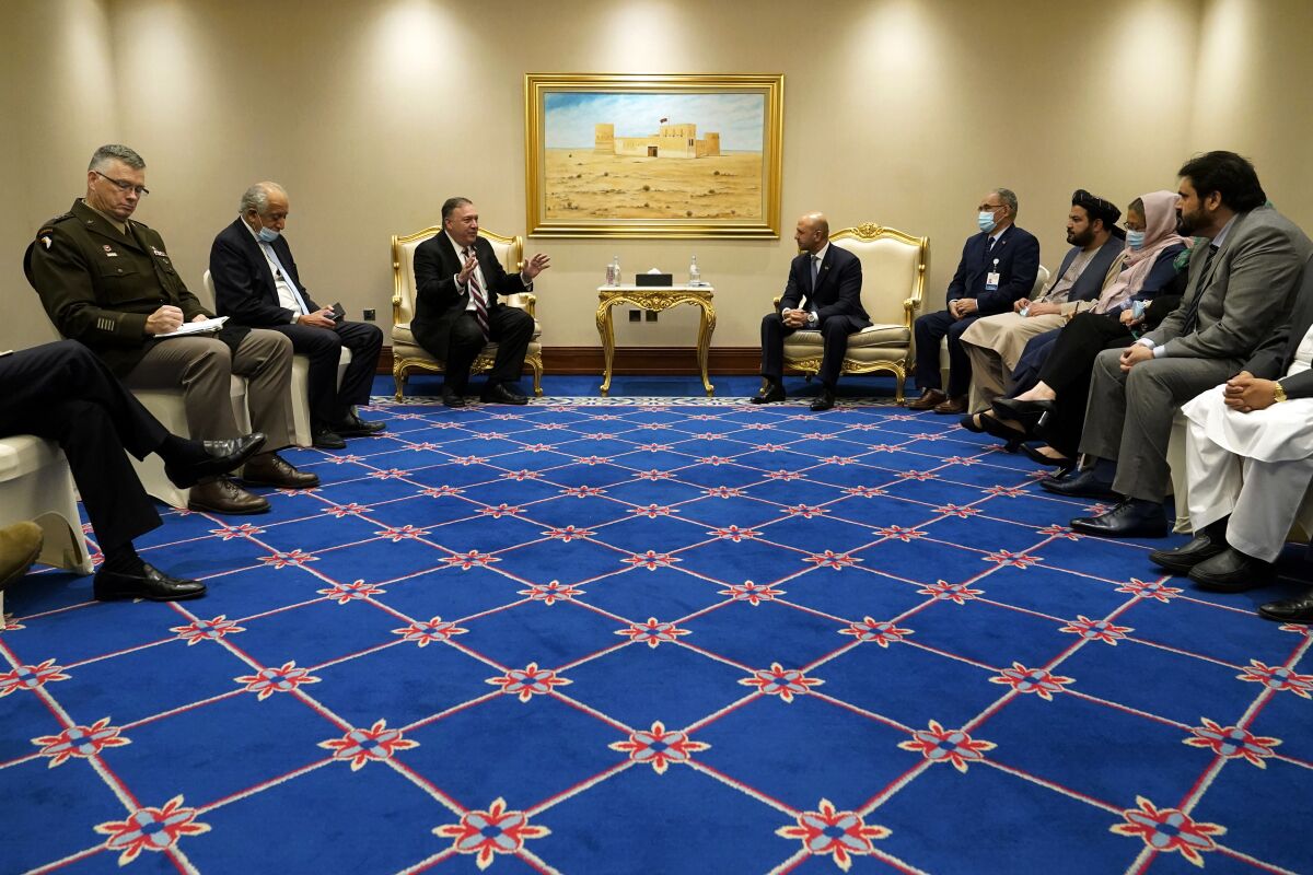 FILE - In this Nov. 21, 2020 file photo, Secretary of State Mike Pompeo, center left, and his aides meet with Afghanistan's State Minister for Peace Sayed Sadat Mansoor Naderi, center right, and the Islamic Republic of Afghanistan's peace negotiation team amid talks between the Afghan government and the Taliban, in Doha, Qatar. Afghan negotiators are to resume talks Tuesday, Jan. 5, 2021, even as hopes are waning, and frustration and fear is growing over a spike in violence that has combatants on both sides blaming the other. The change in the U.S. administration is likely to drag out the opening days of the talks as both sides wait to see whether Biden will stick to the deal brokered by Trump. (AP Photo/Patrick Semansky, Pool, File)