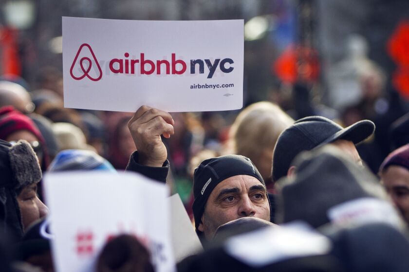 FILE — Supporters of Airbnb hold a rally outside City Hall in New York, Jan. 20, 2015. Airbnb sued New York City, Thursday, June 1, 2023, over an ordinance that the company says imposes arbitrary restrictions that would greatly reduce the local supply of short-term rentals. (AP Photo/Bebeto Matthews, File)