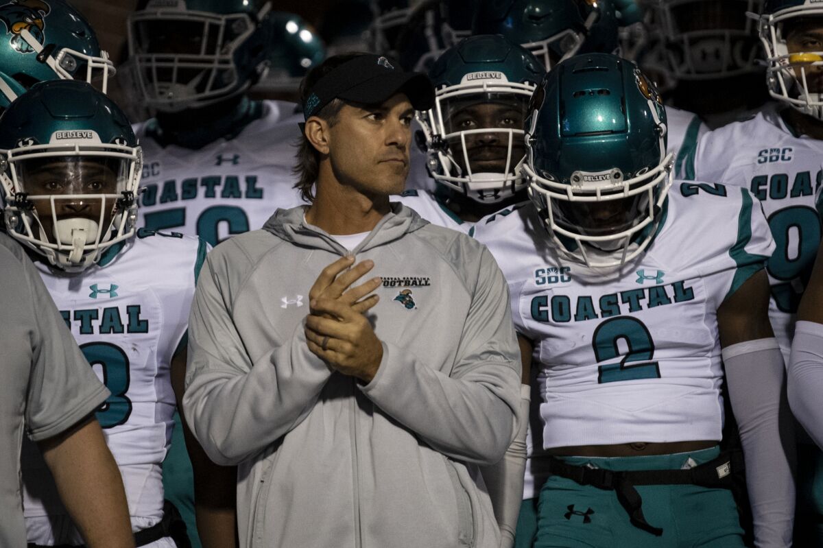 Coastal Carolina coach Jamey Chadwell and players wait in the tunnel before heading out onto the field, for an NCAA college football game against Appalachian State on Thursday, Oct. 21, 2021, in Boone, N.C. (AP Photo/Matt Kelley)