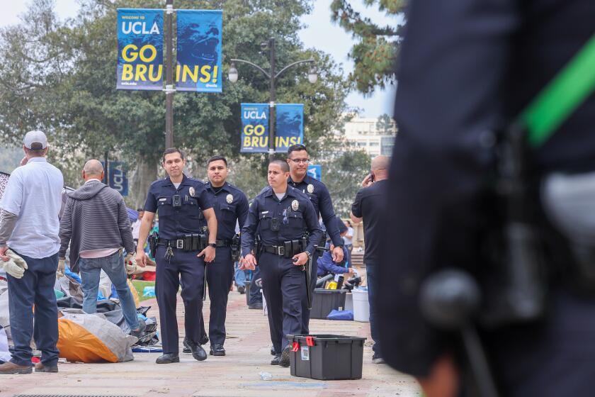 Westwood, CA - May 02: LAPD officers patrol the UCLA campus in the aftermath of the pro-Palestinian encampment being dismantled on Thursday, May 2, 2024 in Westwood, CA. (Brian van der Brug / Los Angeles Times)