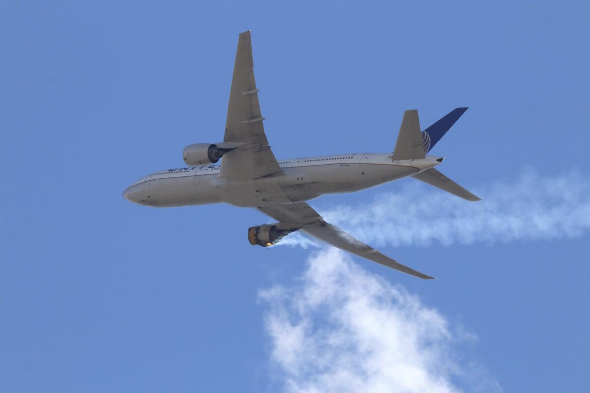  An airplane with a burning engine flies toward the Denver airport.