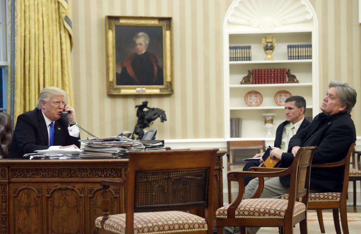 President Trump speaks on the phone with Australian Prime Minister Malcolm Turnbull, with former national security advisor Michael Flynn and former chief strategist Steve Bannon, right, in the Oval Office on Jan. 28, 2017.