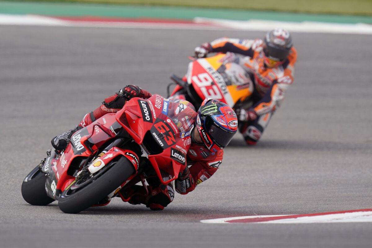 Francesco Bagnaia (63), of Italy, and Marc Marquez (93), of Spain, steer through a turn during an open practice session for the MotoGP Grand Prix of the Americas race at the Circuit of the Americas, Saturday, Oct. 2, 2021, in Austin, Texas. (AP Photo/Eric Gay)