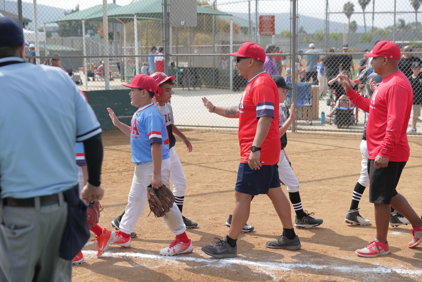Yuma Baseball Academy and Encinitas Edge congratulate each other on a game well-played.