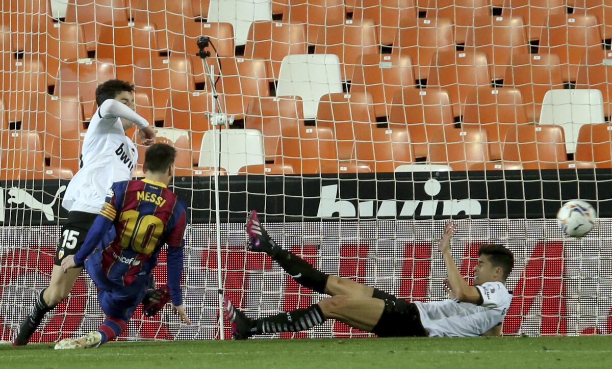Barcelona's Lionel Messi scores his side's first goal during the Spanish La Liga soccer match between Valencia and Barcelona at the Mestalla stadium in Valencia, Spain, Sunday, May 2, 2021. (AP Photo/Alberto Saiz)