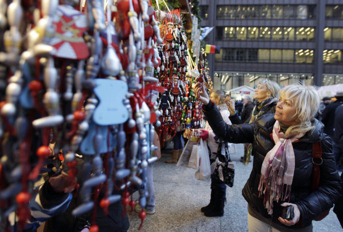 Shoppers check out the goods at the Christkindlmarket in Chicago. Holiday hiring at retailers is headed to a 12-year high, according to a new report.