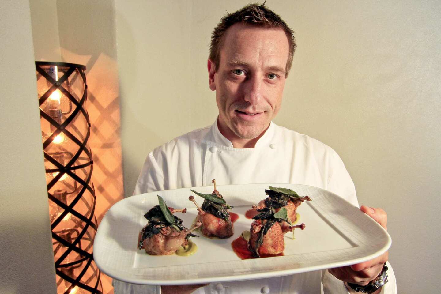 Executive chef Sonny Sweetman displays a dish of Wolfe Ranch quail.