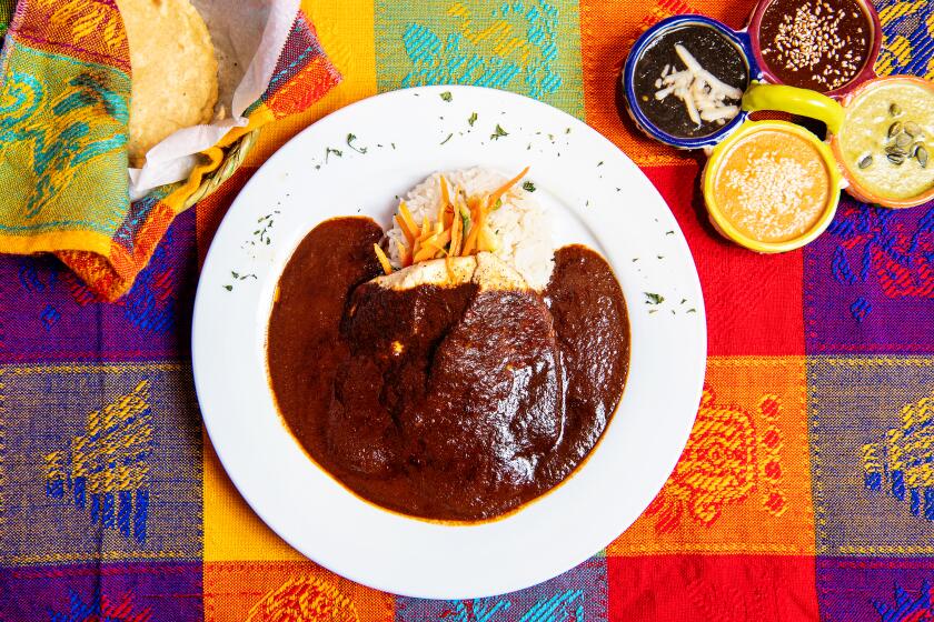 LOS ANGELES, CA- January 2, 2019: Mole de cafe with chicken alongside the Mole Sampler from Mole De Los Reyes on Thursday, January 2, 2019. (Mariah Tauger / Los Angeles Times)