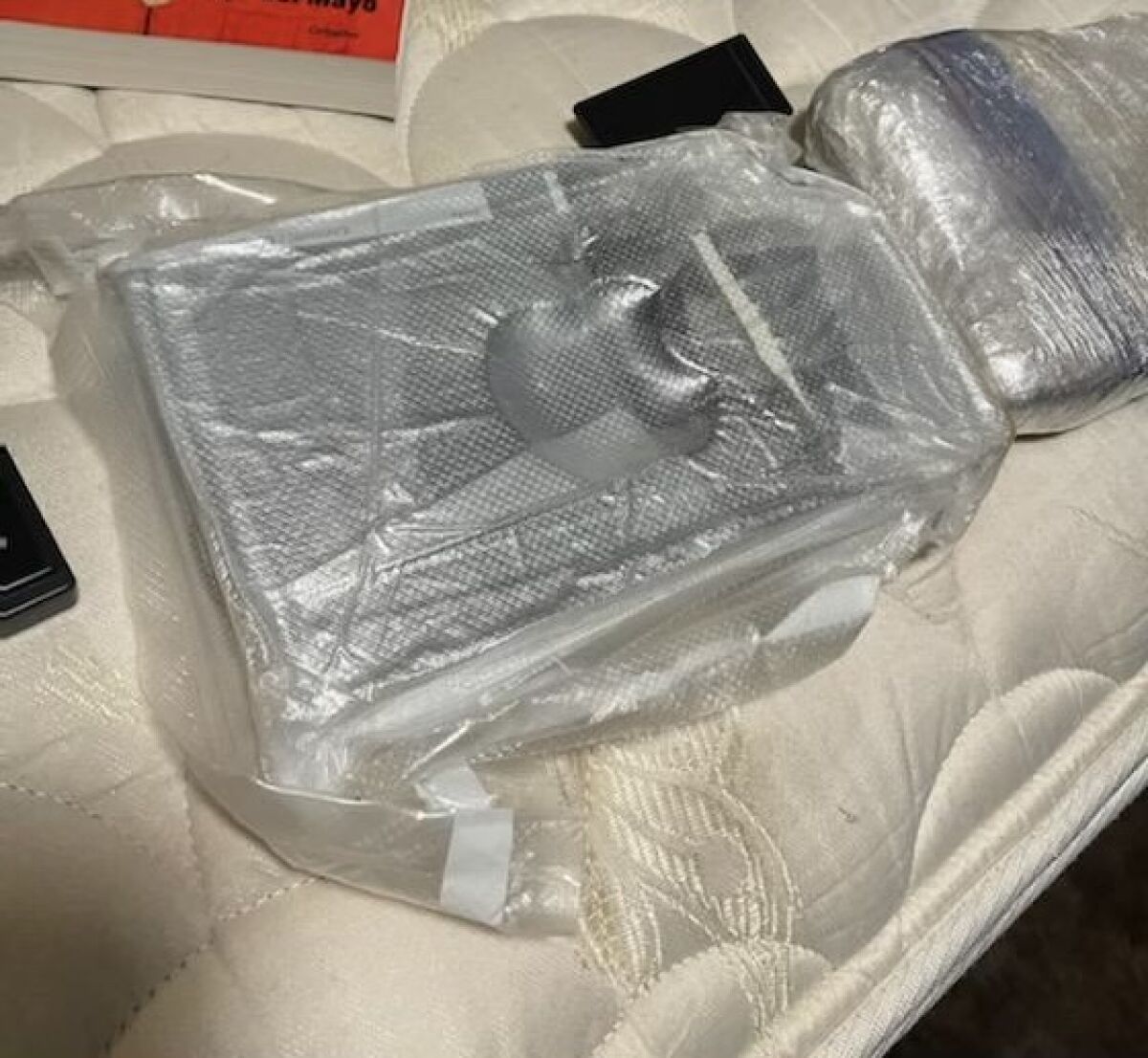 Plastic-wrapped packages sitting on a mattress