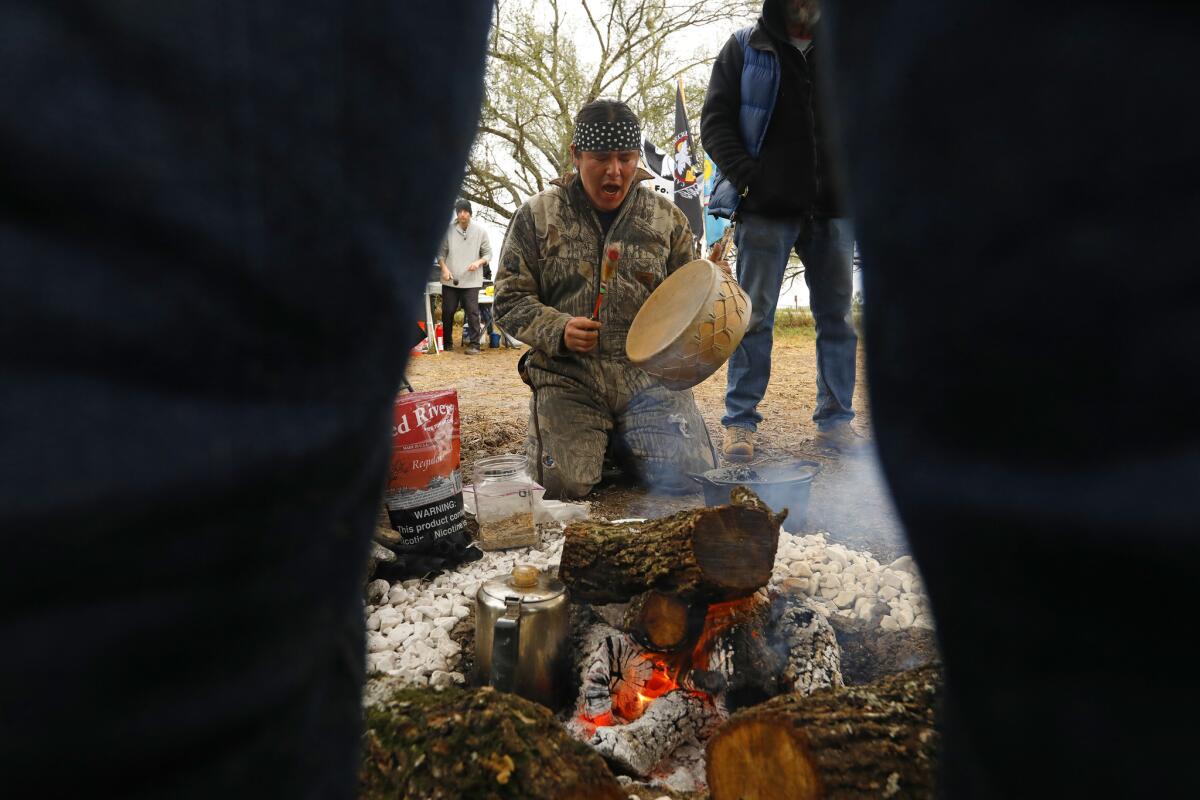 Protesters gather in a prayer circle at a cemetery that could be affected by a border fence.