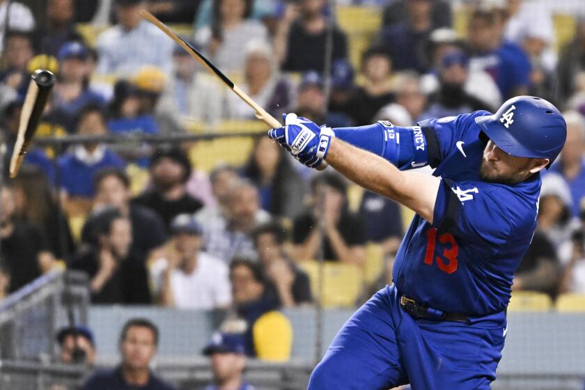 Los Angeles, CA - August 22: Los Angeles Dodgers' Max Muncy breaks his bat after hitting a single during the fourth inning against the Milwaukee Brewers at Dodger Stadium on Monday, Aug. 22, 2022 in Los Angeles, CA.(Wally Skalij / Los Angeles Times)