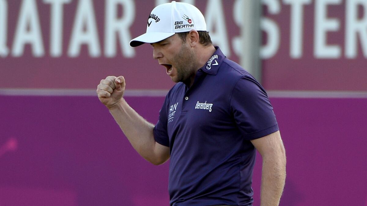 Branden Grace celebrates his birdie putt on the 18th green during his victory at the Qatar Masters on Saturday.