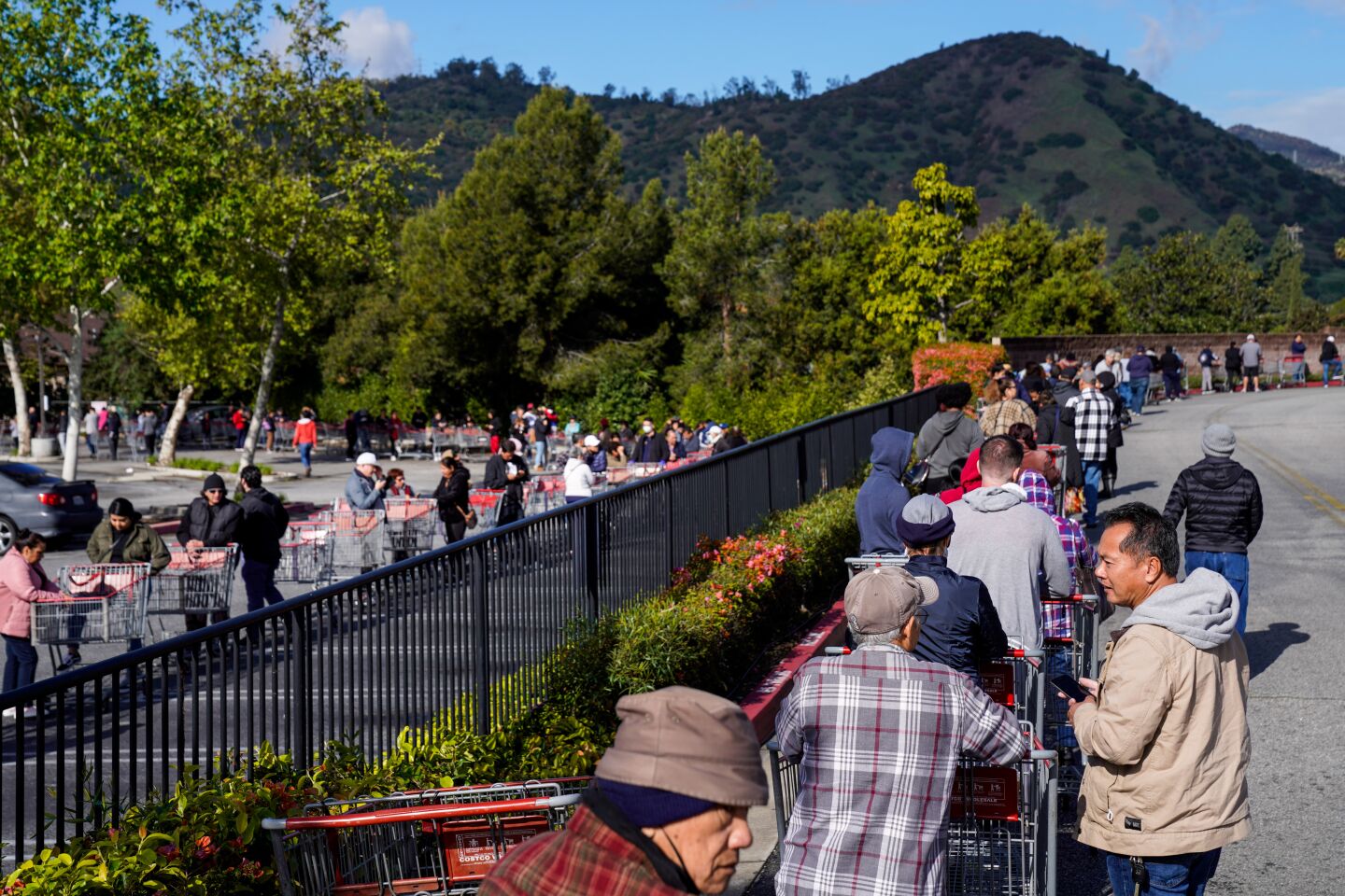 Shoppers queue up ahead of the Los Feliz Costco opening for business on Tuesday, March 17, 2020 in Los Angeles.