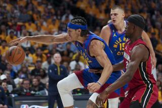 Denver Nuggets forward Aaron Gordon maintains possession of the ball while defended by Miami Heat forward Jimmy Butler.