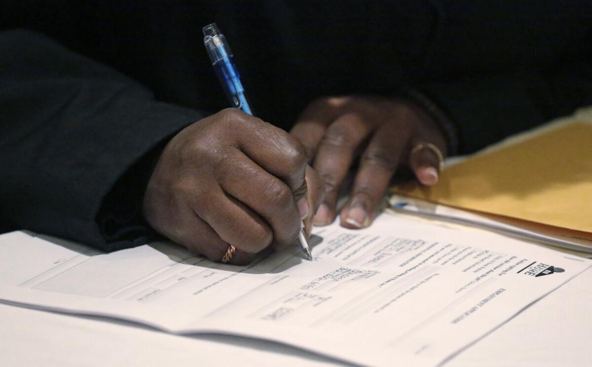 A job seeker fills out an application during a National Career Fairs job fair in Chicago in April.