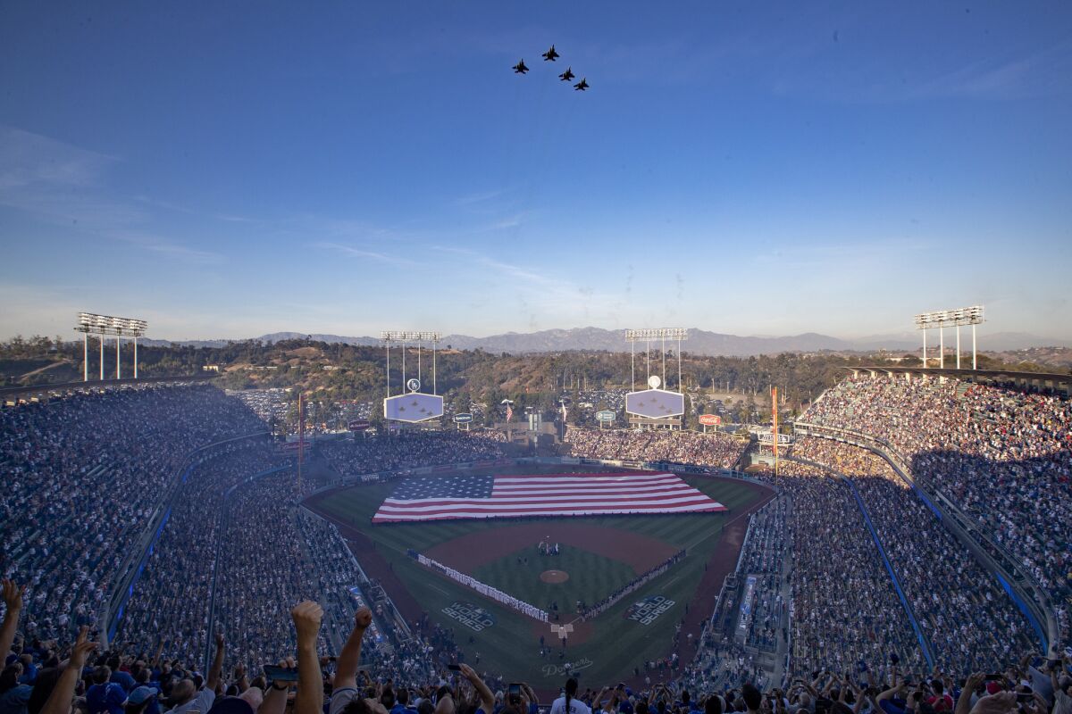 The Fresno Air National Guard 144th Fighter Wing fly over Dodger Stadium as country music star Brad Paisley sings the Star Spangled Banner before Game 3 of the World Series on Friday.