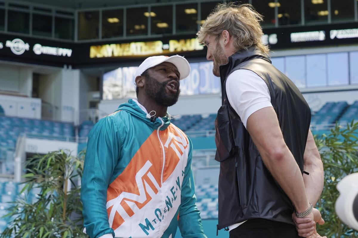 Boxers Floyd Mayweather and Logan Paul taunt each other during a news conference Thursday, May 6, 2021, in Miami Gardens, Fla. Mayweather and Paul are scheduled to face off in an exhibition bout June 6. (AP Photo/Marta Lavandier)
