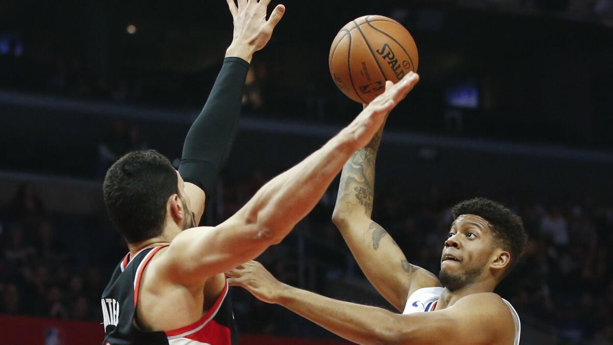 Clippers' Tyrone Wallace (9) shoots over Portland Trail Blazers' Enes Kanter (00) during a the game on Tuesday at Staples Center.