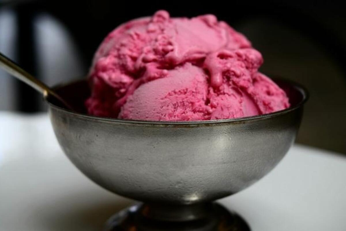 Deep pink gelato in a silver metal bowl