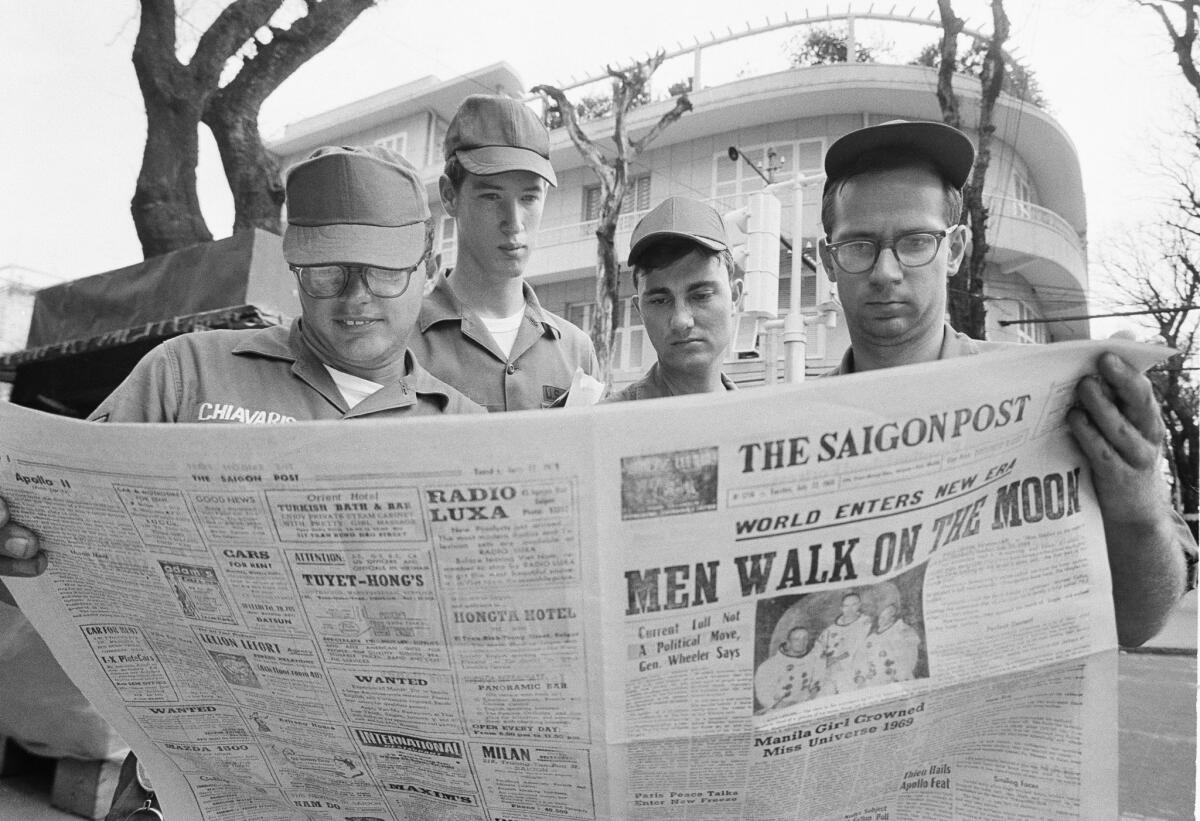 American troops in Vietnam read about the July 20, 1969, moon landing.